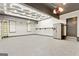 Spacious garage with epoxy flooring, modern lighting, and ample storage space at 121 Fairway Overlook, Woodstock, GA 30188