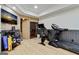 Home gym featuring exposed brick wall, slat sauna, mounted TV, and exercise equipment at 121 Fairway Overlook, Woodstock, GA 30188