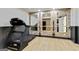 Home gym featuring mirrors, ballet bar, exercise equipment, and exposed brick accents at 121 Fairway Overlook, Woodstock, GA 30188