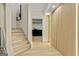 Hallway with wood slat wall and led lighting adjacent to carpeted stairs, providing a modern look at 121 Fairway Overlook, Woodstock, GA 30188