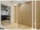 Hallway with wood slat wall and led lighting leading to the home gym at 121 Fairway Overlook, Woodstock, GA 30188