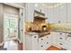 Modern kitchen featuring white cabinets, brick backsplash, granite countertops and stainless steel appliances at 121 Fairway Overlook, Woodstock, GA 30188