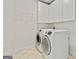 Bright laundry room with updated washer and dryer, white cabinets, and a storage rack for convenience at 121 Fairway Overlook, Woodstock, GA 30188