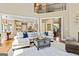 Open-concept living room with a view into the kitchen, and staircase with views to the loft area at 121 Fairway Overlook, Woodstock, GA 30188