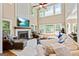 Spacious living room featuring a fireplace, large windows, comfortable seating, and hardwood floors at 121 Fairway Overlook, Woodstock, GA 30188