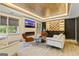 Open living room with fireplace, wet bar, coffered ceilings, modern furniture and lots of natural light at 121 Fairway Overlook, Woodstock, GA 30188