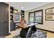 Inviting office with custom built-ins, a sleek desk, a bright window, and plush rug at 121 Fairway Overlook, Woodstock, GA 30188