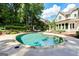 Backyard pool features a stone surround and patio furniture at 121 Fairway Overlook, Woodstock, GA 30188