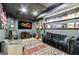Basement recreation room featuring a large tv, instruments, recording decor, and a comfortable lounge area at 121 Fairway Overlook, Woodstock, GA 30188