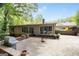This backyard boasts a grill area, brick patio, and lush greenery, perfect for outdoor entertaining and relaxation at 2917 Rockingham Nw Dr, Atlanta, GA 30327