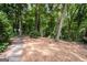 A serene backyard featuring a wood path surrounded by mature trees, offering a private oasis at 2917 Rockingham Nw Dr, Atlanta, GA 30327