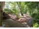 A sprawling backyard featuring brick steps, mature trees, and ample green space for outdoor activities at 2917 Rockingham Nw Dr, Atlanta, GA 30327