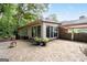 A large backyard featuring a brick patio with an outdoor fireplace and mature trees, creating a private setting at 2917 Rockingham Nw Dr, Atlanta, GA 30327