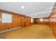 Expansive basement featuring paneled walls, carpet flooring, and bright windows at 2917 Rockingham Nw Dr, Atlanta, GA 30327