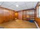 Spacious basement boasts classic paneling and built-in shelving, perfect for storage at 2917 Rockingham Nw Dr, Atlanta, GA 30327
