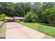 Long driveway leading to a charming ranch home, surrounded by mature trees and lush greenery at 2917 Rockingham Nw Dr, Atlanta, GA 30327