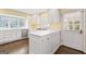 Sunlit kitchen featuring white cabinetry, stainless steel appliances, and hardwood floors at 2917 Rockingham Nw Dr, Atlanta, GA 30327