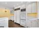 Bright kitchen featuring white cabinets, stainless steel appliances, and a view from the bay window at 2917 Rockingham Nw Dr, Atlanta, GA 30327