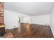 Bright living room featuring hardwood floors, a charming brick fireplace, and expansive windows showcasing natural light at 2917 Rockingham Nw Dr, Atlanta, GA 30327