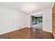 Empty living room showcasing hardwood floors, a chandelier, and a brick wall accent at 2917 Rockingham Nw Dr, Atlanta, GA 30327