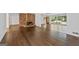 Open-concept living area with hardwood floors, a brick fireplace, and large windows overlooking the backyard at 2917 Rockingham Nw Dr, Atlanta, GA 30327