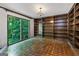 Office space with built-in bookshelves, hardwood floors, and a large window overlooking the lush outdoors at 2917 Rockingham Nw Dr, Atlanta, GA 30327
