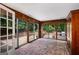 Enclosed sunroom with brick flooring, wood-paneled walls, and sliding glass doors at 2917 Rockingham Nw Dr, Atlanta, GA 30327