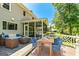 Stylish back deck featuring comfortable seating, outdoor dining set, and screened porch offering outdoor relaxation at 115 Edgewater Way, Peachtree City, GA 30269