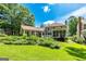 Expansive backyard with lush greenery, mature trees, and a charming patio, providing ample space for outdoor activities at 115 Edgewater Way, Peachtree City, GA 30269
