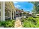Expansive backyard with a stone pathway, lush landscaping, and a covered porch for outdoor relaxation at 115 Edgewater Way, Peachtree City, GA 30269