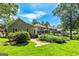 Serene backyard featuring lush landscaping, mature trees, and an inviting screened porch for ultimate relaxation at 115 Edgewater Way, Peachtree City, GA 30269