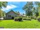 Expansive backyard featuring lush greenery, manicured lawn, and mature trees providing a peaceful and private oasis at 115 Edgewater Way, Peachtree City, GA 30269