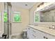 Bathroom with a marble vanity, dual sinks, walk in shower, and natural light at 115 Edgewater Way, Peachtree City, GA 30269