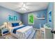 Serene bedroom with blue walls, matching bedding, and charming nautical-themed decor at 115 Edgewater Way, Peachtree City, GA 30269