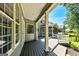 Charming covered deck with French doors, wood flooring, and stylish columns perfect for entertaining at 115 Edgewater Way, Peachtree City, GA 30269