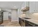 Contemporary kitchen featuring stainless steel appliances, dark cabinets, and a gas range at 115 Edgewater Way, Peachtree City, GA 30269
