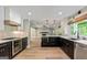 Modern kitchen with sleek black and white cabinets, stainless steel appliances, and hardwood floors throughout at 115 Edgewater Way, Peachtree City, GA 30269