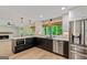 Modern kitchen featuring stainless steel appliances, white countertops, and a breakfast bar at 115 Edgewater Way, Peachtree City, GA 30269