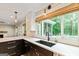 Bright and airy kitchen with black cabinets, white countertops, and natural lighting at 115 Edgewater Way, Peachtree City, GA 30269
