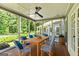 Relaxing screened porch with comfortable seating and a ceiling fan, perfect for enjoying the outdoors in comfort at 115 Edgewater Way, Peachtree City, GA 30269