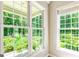 Bright room with large windows offering views of the lush, green landscape and natural light at 115 Edgewater Way, Peachtree City, GA 30269