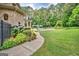 Beautiful backyard with a lush lawn, in-ground pool, patio, and well-manicured landscaping at 310 Westbourne Dr, Tyrone, GA 30290