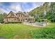 Sprawling backyard with an in-ground pool, screened in porch, and luscious, green lawn at 310 Westbourne Dr, Tyrone, GA 30290