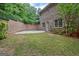 Backyard features a private patio area, green lawn, and brick fence at 310 Westbourne Dr, Tyrone, GA 30290