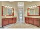 Dual vanity bathroom with granite counters, shower, and decorative mirrors at 310 Westbourne Dr, Tyrone, GA 30290