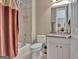 Well-lit bathroom with shower-tub combination, white vanity with granite top, and large mirror at 310 Westbourne Dr, Tyrone, GA 30290