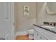 Powder room featuring a granite countertop and decorative mirror at 310 Westbourne Dr, Tyrone, GA 30290