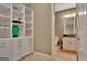 Bathroom adjacent to closet space with granite counters and a tile floor at 310 Westbourne Dr, Tyrone, GA 30290