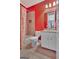 Bright red bathroom with shower-tub, tile surround, white vanity, and granite countertop at 310 Westbourne Dr, Tyrone, GA 30290