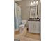 A well-lit bathroom with a world map shower curtain at 310 Westbourne Dr, Tyrone, GA 30290